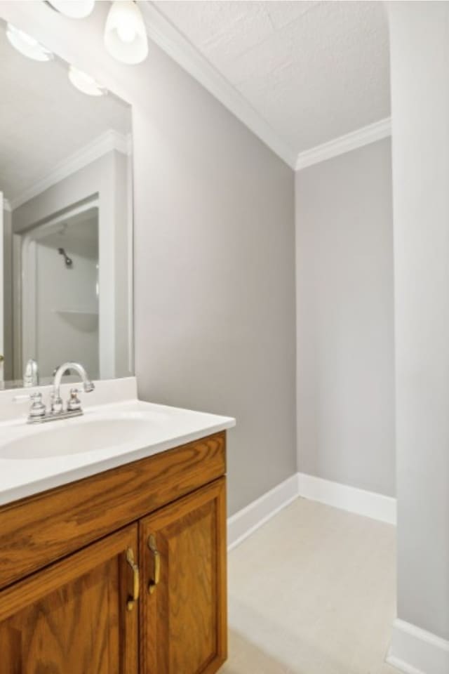 bathroom with vanity and ornamental molding