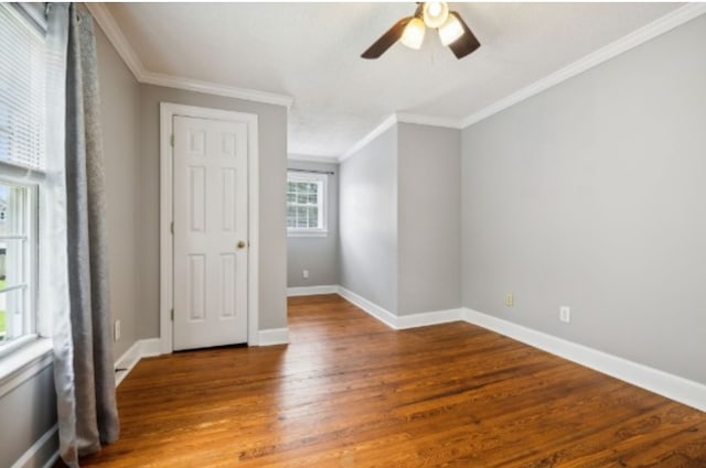 empty room with hardwood / wood-style flooring, ceiling fan, and ornamental molding