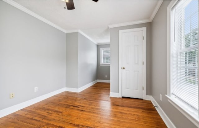 empty room featuring hardwood / wood-style flooring, ceiling fan, and crown molding