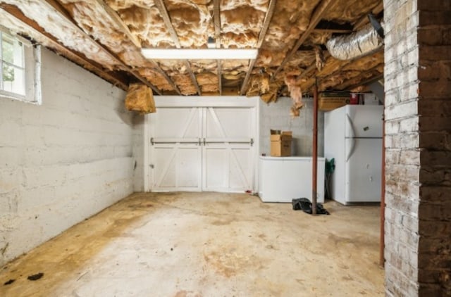 basement featuring white fridge