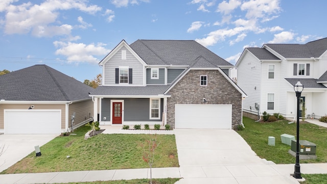 view of front property featuring a front yard, a porch, and a garage