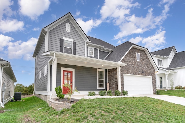 view of front facade with a porch, central AC unit, a front yard, and a garage