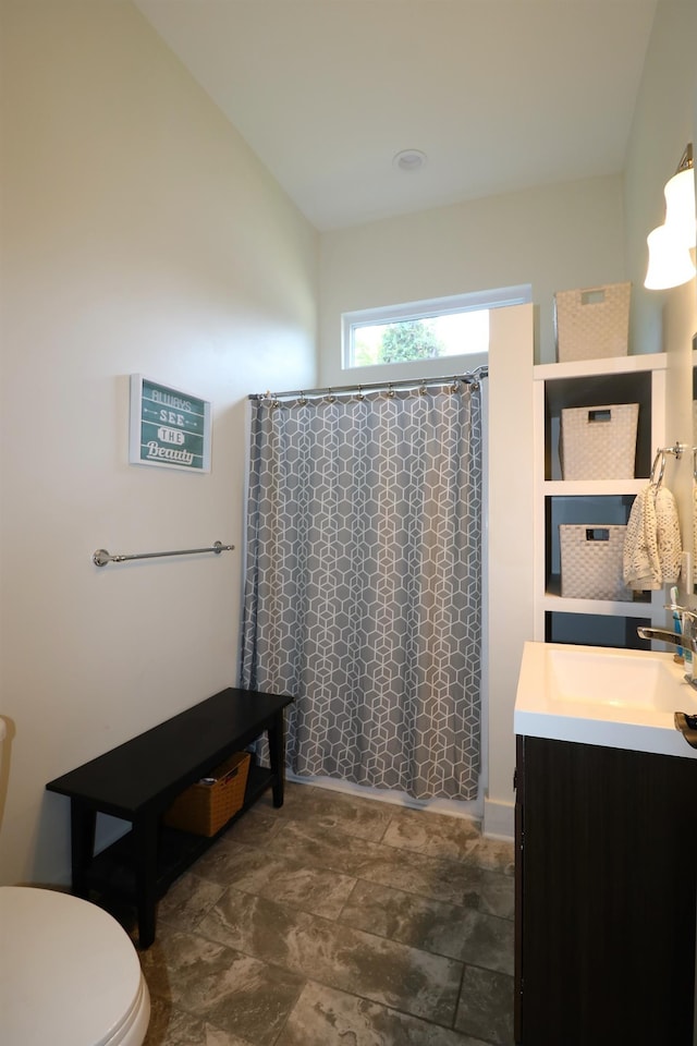 bathroom with vanity, toilet, and walk in shower