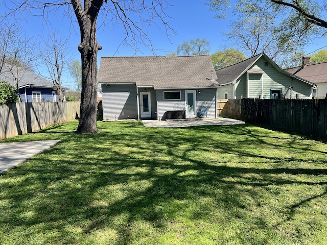 back of house with a lawn and a patio area