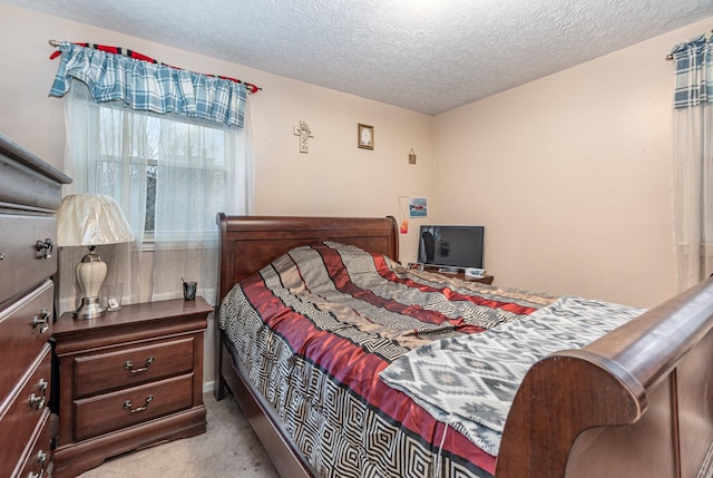 carpeted bedroom with a textured ceiling