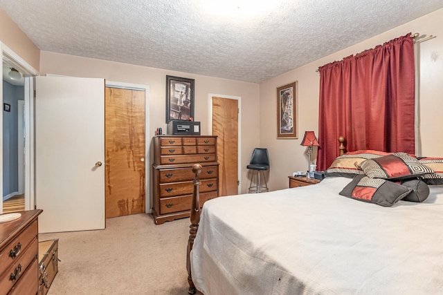 carpeted bedroom featuring a textured ceiling and a closet