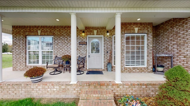 view of exterior entry with a porch