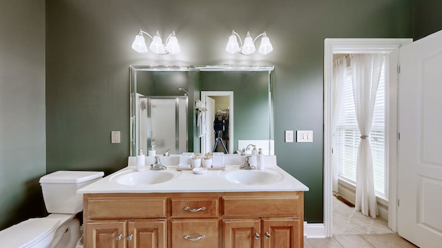 bathroom with plenty of natural light, vanity, an enclosed shower, and toilet