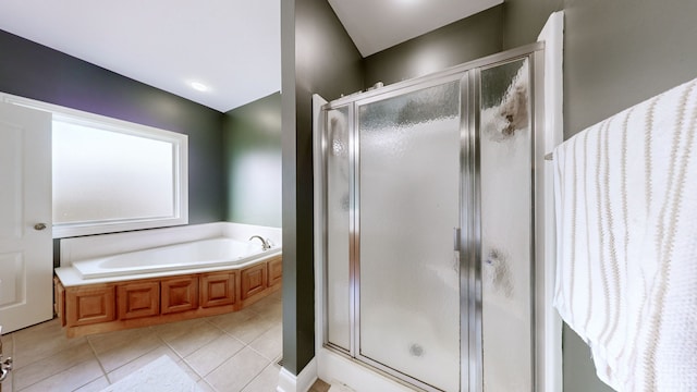 bathroom featuring plus walk in shower and tile patterned flooring