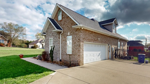 view of side of property featuring a lawn and a garage