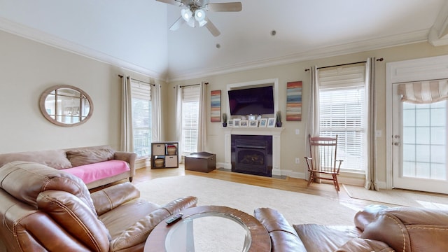 living room with hardwood / wood-style floors, vaulted ceiling, ceiling fan, and ornamental molding