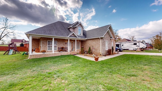 view of front of house featuring a playground and a front lawn