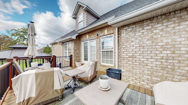 wooden deck featuring a grill