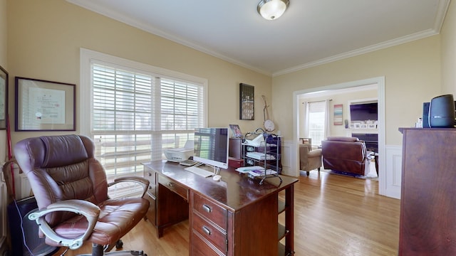 office with a healthy amount of sunlight, light wood-type flooring, and crown molding