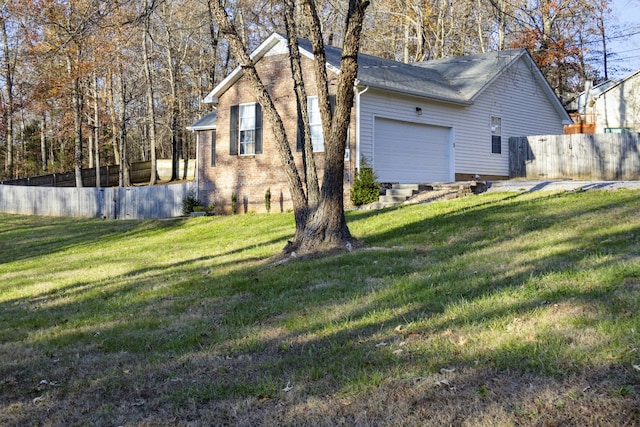 view of side of home with a garage and a yard