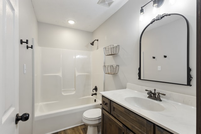 full bathroom featuring toilet, vanity, bathtub / shower combination, and hardwood / wood-style flooring