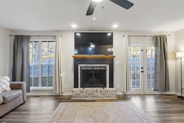 unfurnished living room with plenty of natural light, dark hardwood / wood-style floors, and french doors