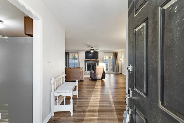 entrance foyer with ceiling fan, a textured ceiling, and hardwood / wood-style flooring