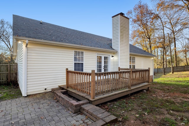 rear view of house featuring a patio, a wooden deck, and french doors