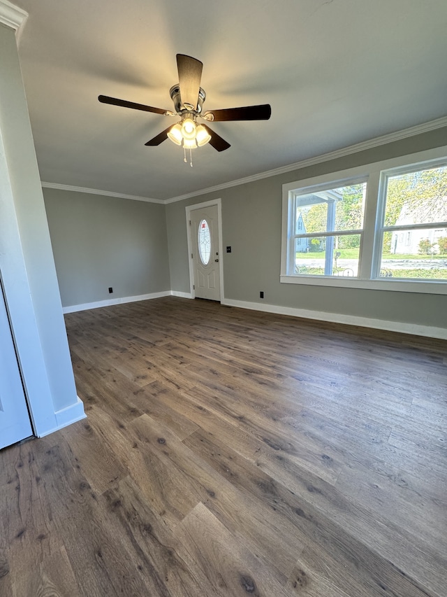 entrance foyer featuring baseboards, ornamental molding, ceiling fan, and dark wood-style flooring