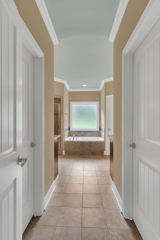 hall featuring crown molding and light tile patterned flooring