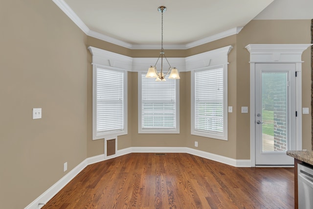 unfurnished dining area with dark hardwood / wood-style flooring, ornamental molding, and a chandelier