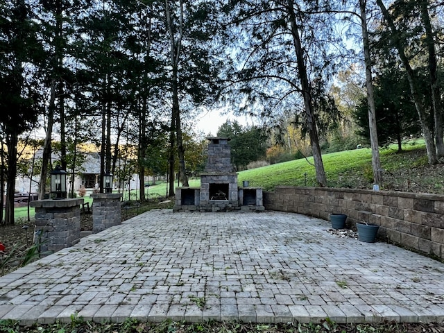 view of patio / terrace featuring an outdoor stone fireplace