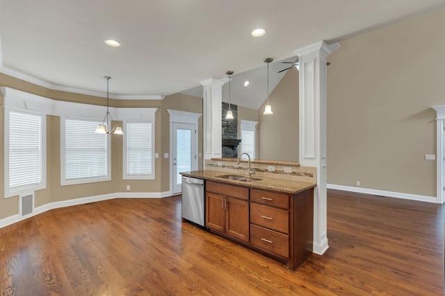 kitchen with sink, stainless steel dishwasher, dark hardwood / wood-style floors, pendant lighting, and ceiling fan with notable chandelier