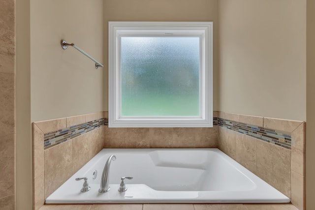 bathroom featuring tiled tub