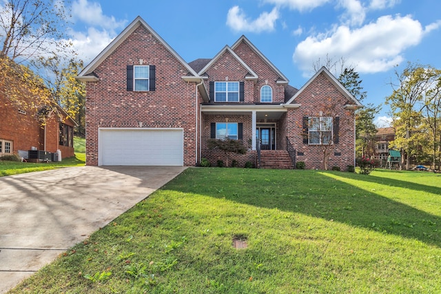 view of property with a garage and a front lawn