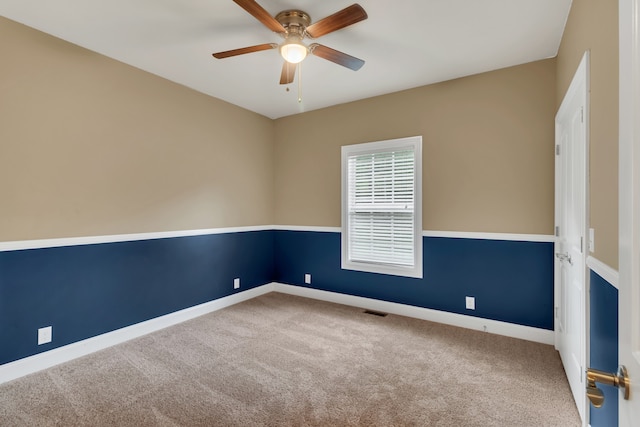 spare room featuring carpet flooring and ceiling fan