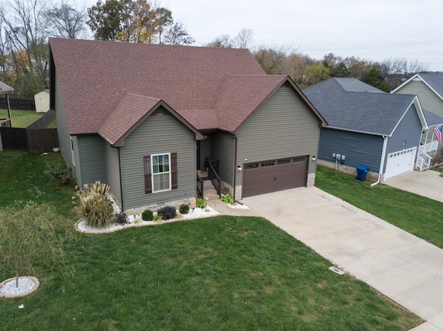 view of front of home featuring a front yard and a garage