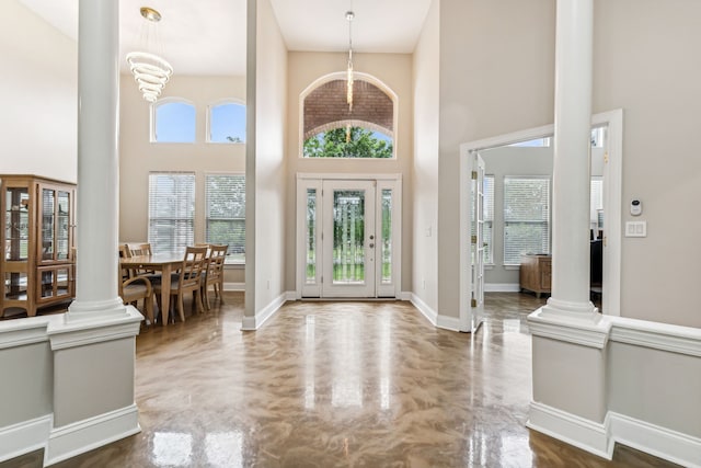 foyer with a high ceiling and a notable chandelier