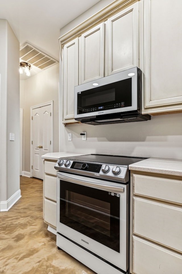 kitchen with cream cabinets and electric range oven