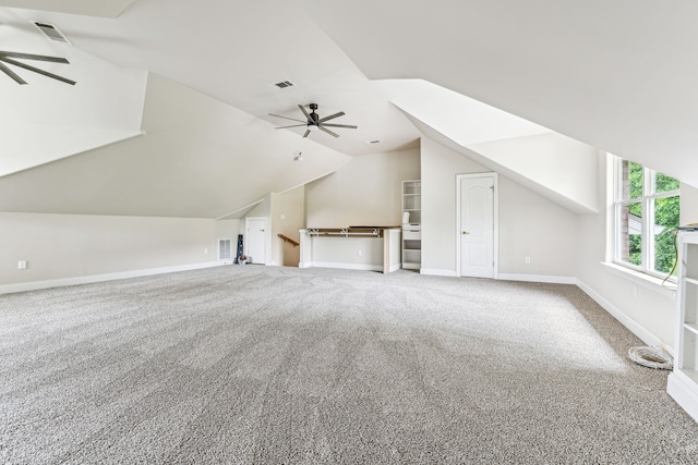 additional living space with carpet flooring, ceiling fan, and vaulted ceiling