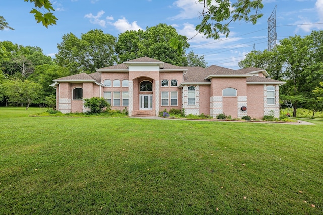 mediterranean / spanish house featuring a front lawn