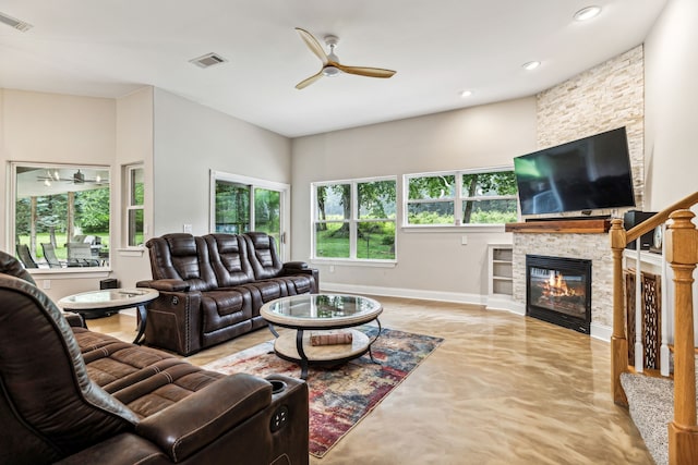 living room with a fireplace and ceiling fan