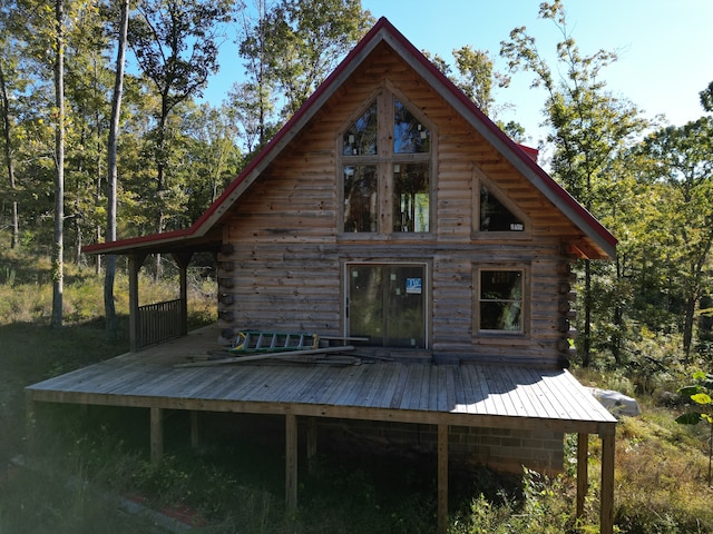 back of house with a wooden deck