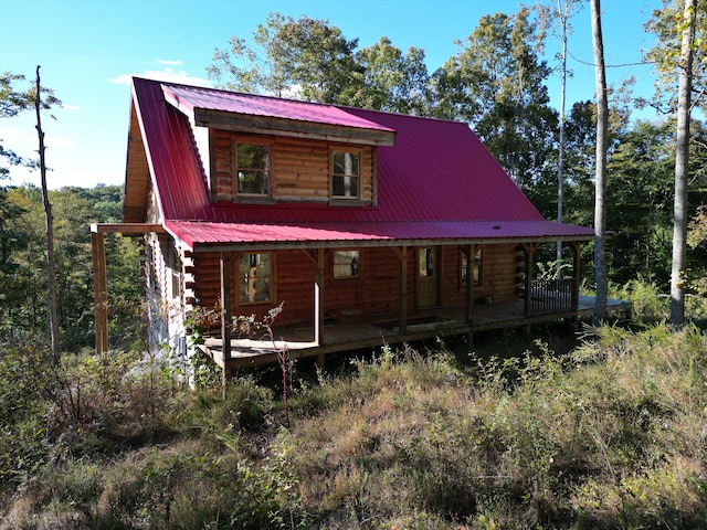 rear view of house featuring a porch