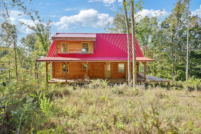 view of side of property with a porch