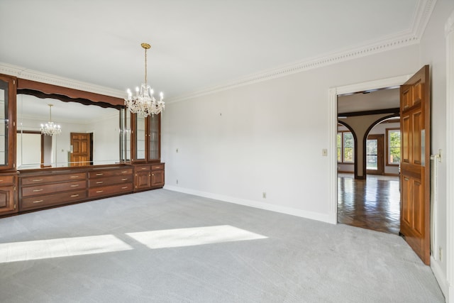 interior space featuring ornamental molding and a notable chandelier