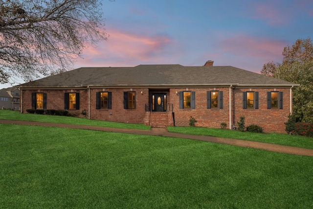 ranch-style home with a lawn