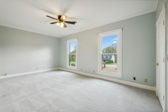 spare room with light carpet, crown molding, and ceiling fan