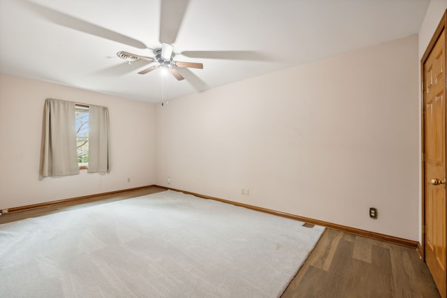 unfurnished room with ceiling fan and wood-type flooring