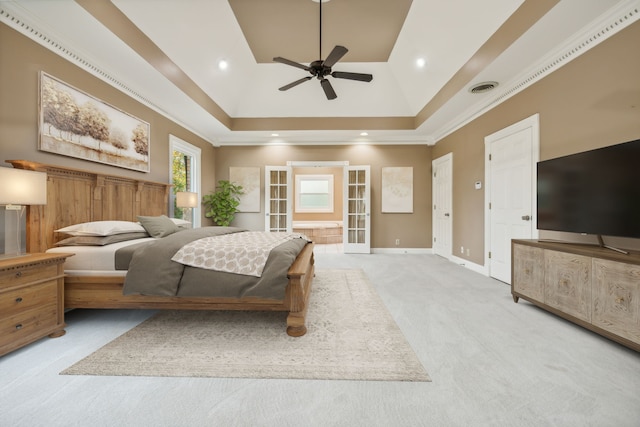 bedroom featuring carpet, french doors, crown molding, ceiling fan, and a tray ceiling