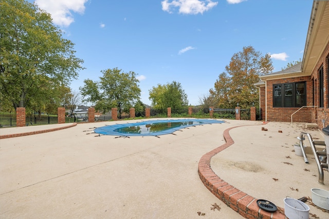 view of swimming pool featuring a patio