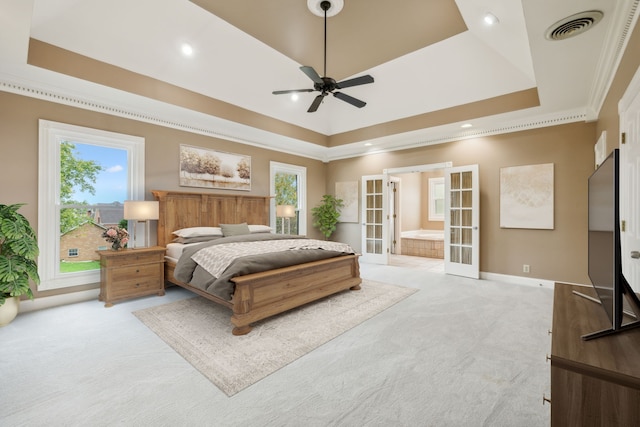 bedroom featuring french doors, a tray ceiling, and ceiling fan