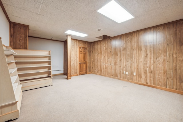 basement with wood walls and light carpet