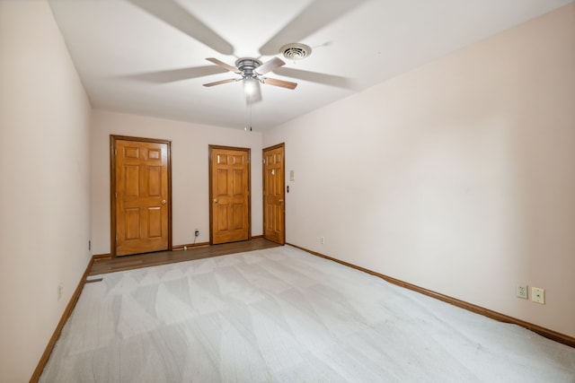 unfurnished bedroom featuring light colored carpet and ceiling fan