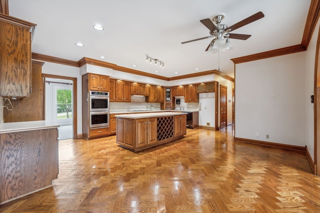 kitchen featuring a center island, stainless steel double oven, and ornamental molding